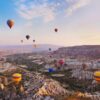 Hot Air Balloons Flying Above Fairy Chimneys In Cappadocia- Private Ephesus Tours