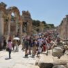 A Group Of Tourists Walking On The Famous Marble Street Of Ephesus